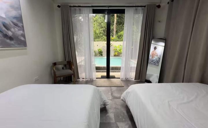 Bedroom with a glass door to the pool